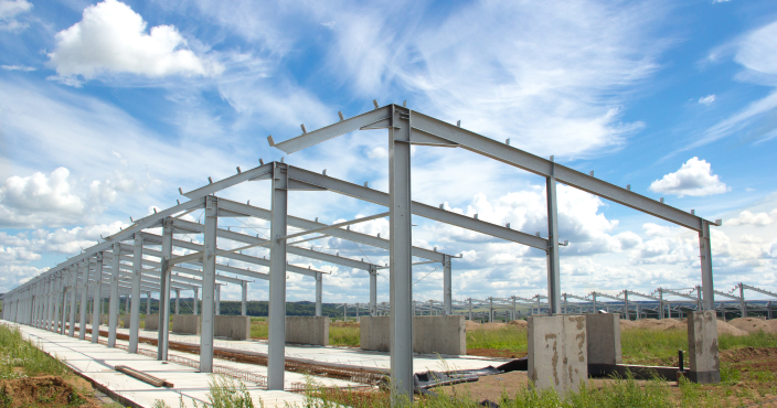 Interior view of a hydroponic plant factory with metal racks.